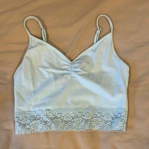 Light blue cropped tank top with mesh on bottle